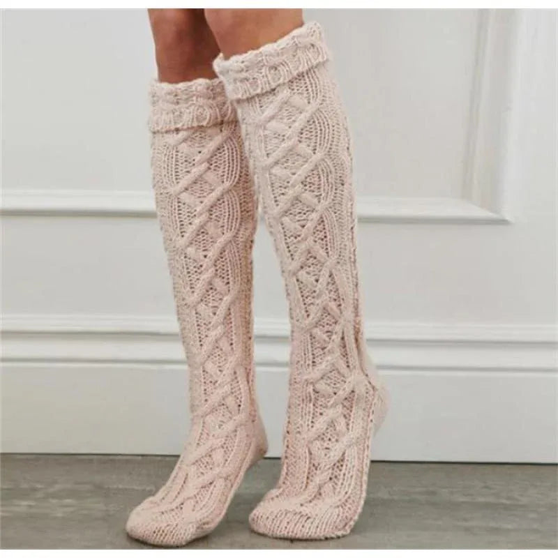 Pink knitted knee socks, delicate cable-knit panels and ribbed cuff