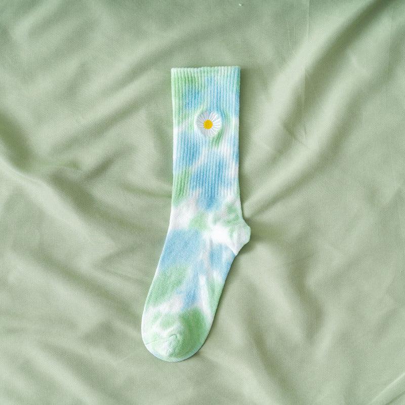 Tie-dye daisy print stockings in light blue, green with a yellow daisy detail