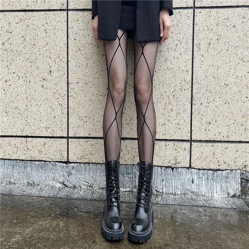 Black fishnet stockings with small diamond mesh, full-length, worn with boots