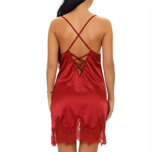 Red satin chemise dress with crisscross open-back straps and lace hem.