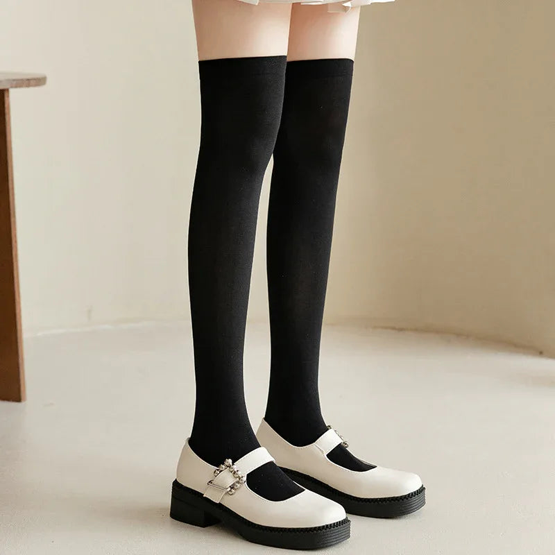 Black thin over-the-knee stockings, straight-leg fit with wide top band and sheer knit