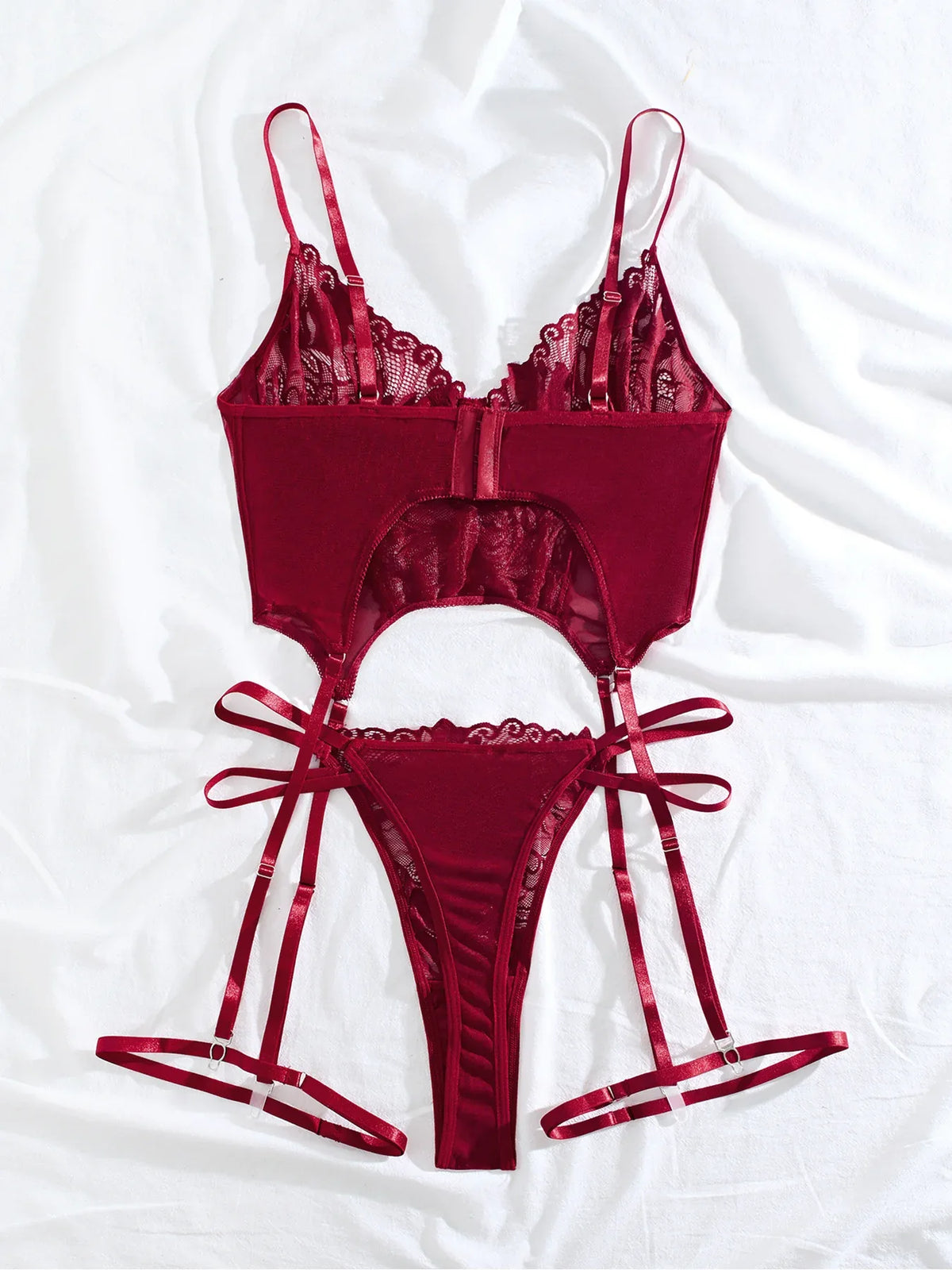 Flat lay: purplish red lace bra, lace brief, and garter straps set