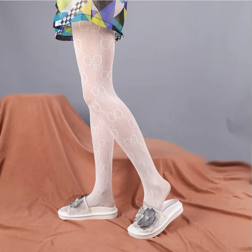 White flocking tights with repeating pattern, full length on feet