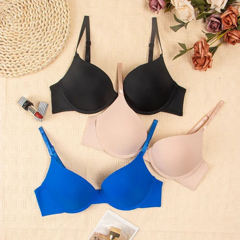 Push-up bra set in black, beige, blue, and white, showing molded cups and straps.