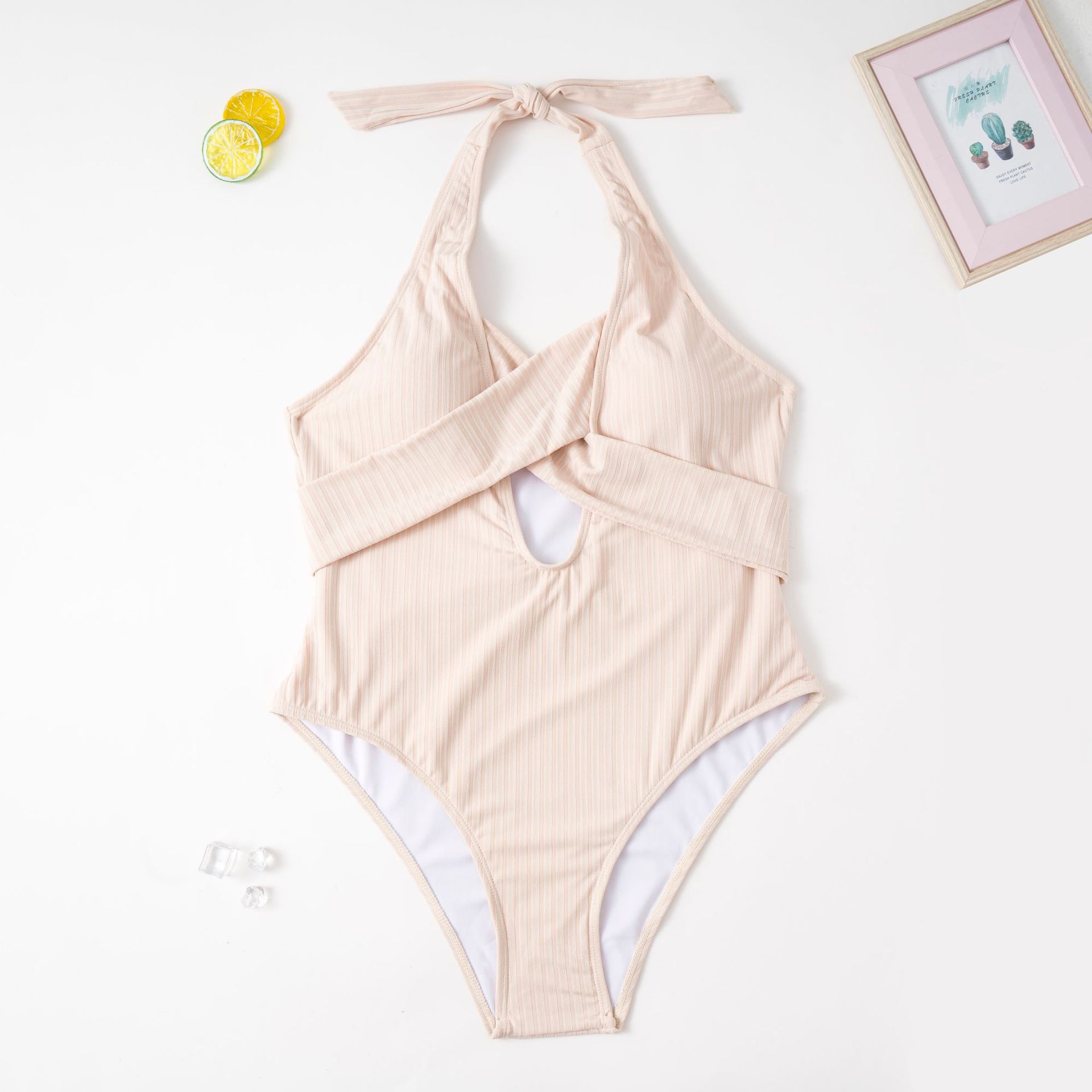 Beige ribbed one-piece swimsuit with halter neck and center cutout