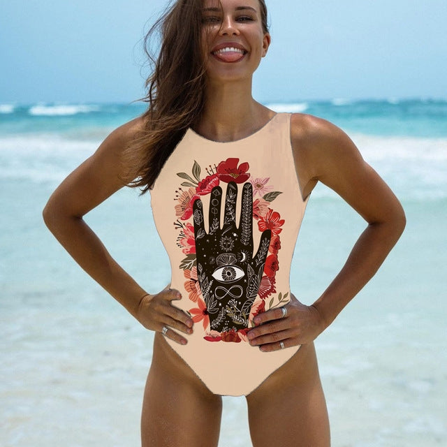 One-piece swimsuit with beige base, red floral and black hand print, sleeveless