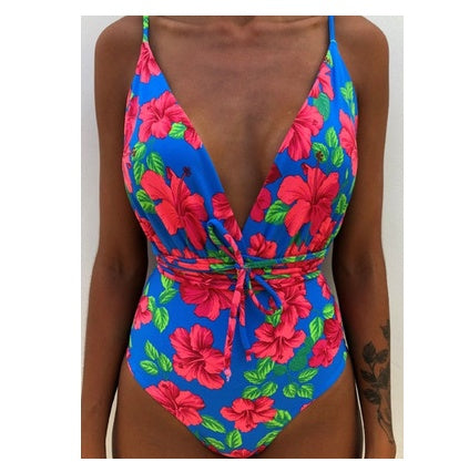 Backless monokini swimsuit with bright blue base and pink floral pattern