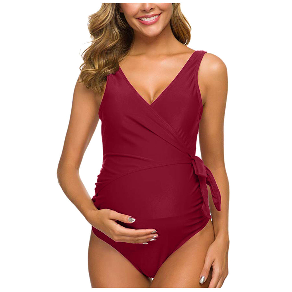 Maroon maternity one-piece swimsuit with V-neck and side waist tie