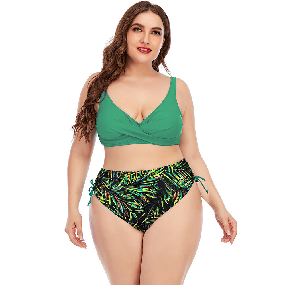 Two-piece swimwear set with green V-neck bikini top and tropical leaf print high-rise bottoms