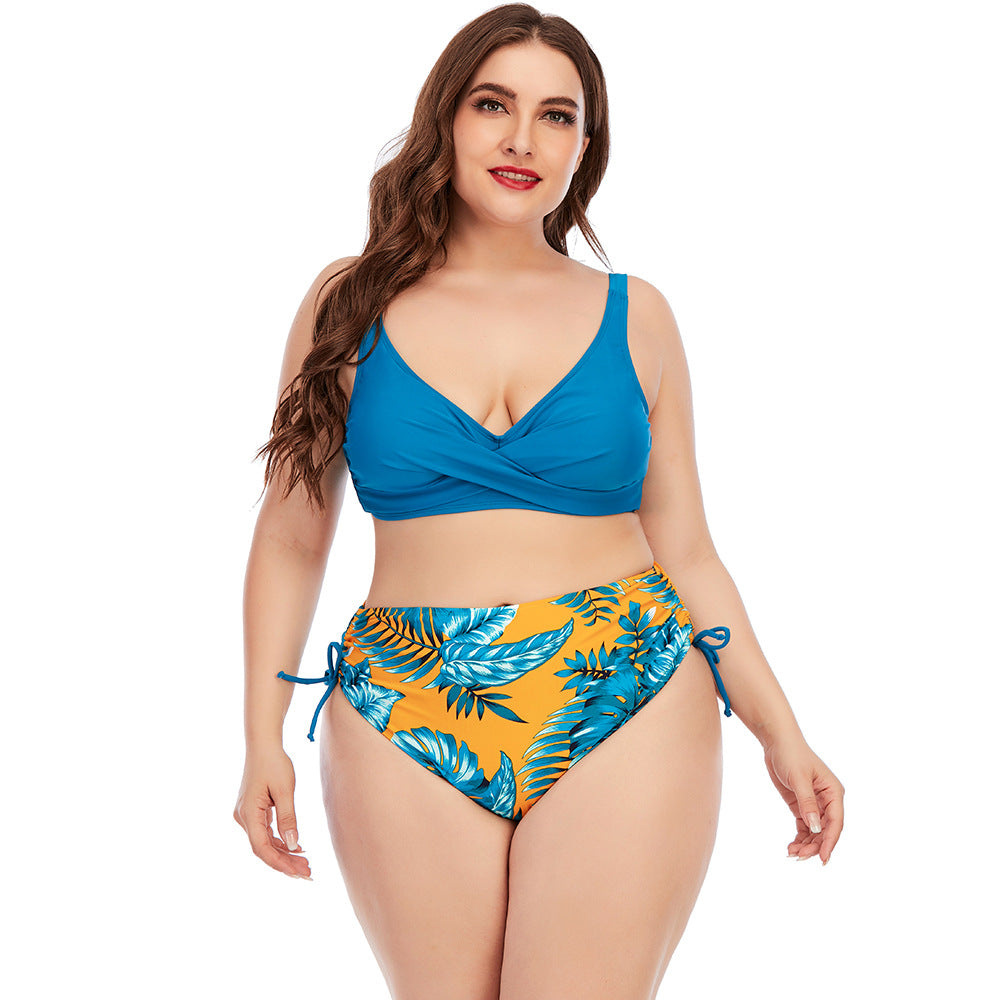 Two-piece swimwear set with blue V-neck bikini top and tropical leaf print high-rise bottoms