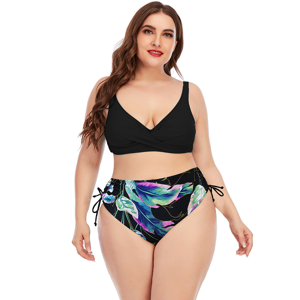 Two-piece swimwear set with black V-neck bikini top and colorful tropical print high-rise bottoms