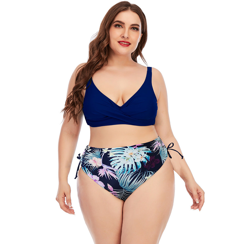 Two-piece swimwear set with navy V-neck bikini top and tropical floral palm print high-rise bottoms