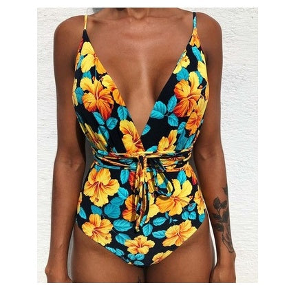 Backless one-piece monokini with navy and yellow hibiscus print, deep V and tie waist