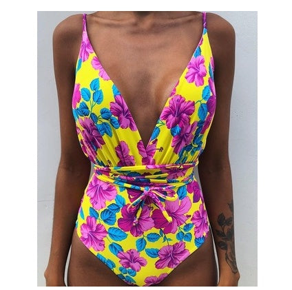 Backless one-piece monokini with bright purple floral print, deep V and tied waist