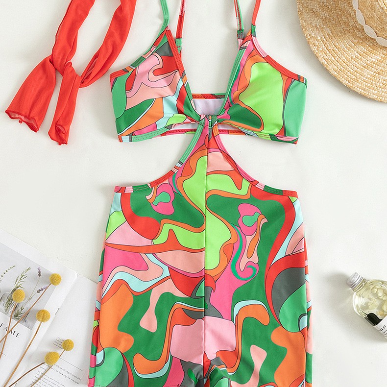 One-piece swimsuit front with abstract retro print, halter neckline and center tie knot