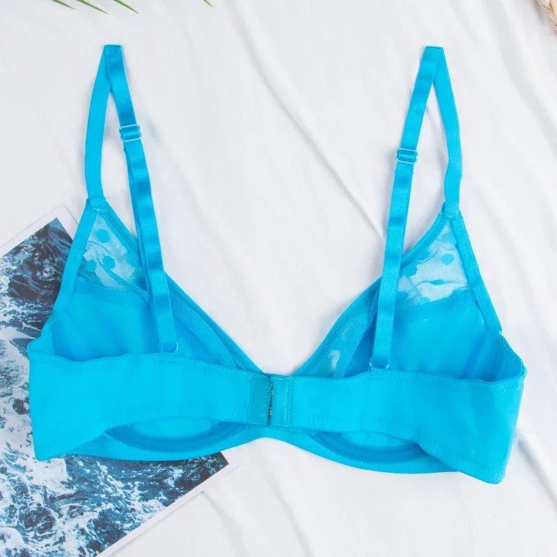 Blue polka-dot lingerie bra flat lay, triangle cups and adjustable straps