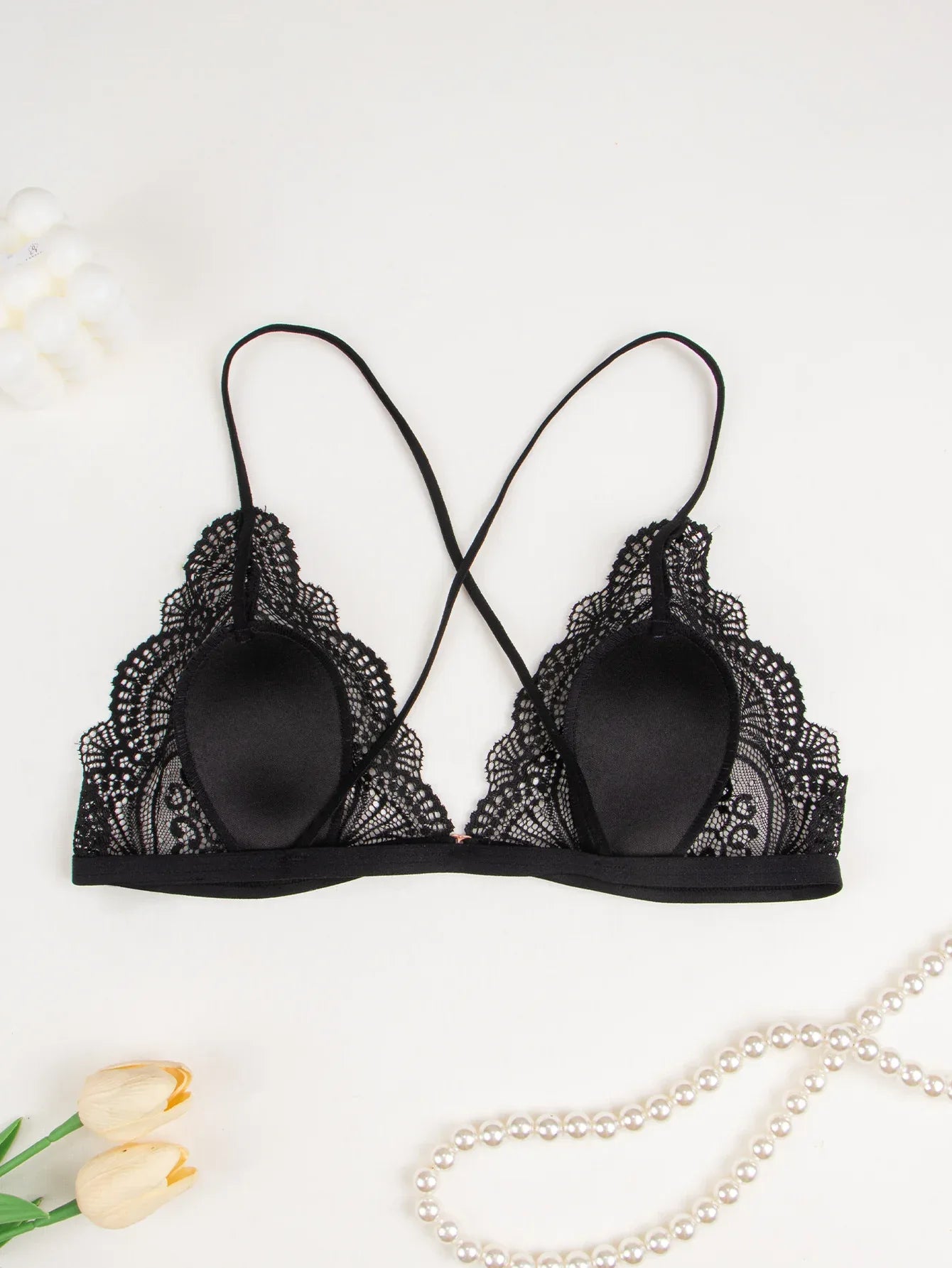 Black lace lingerie set bra front view: molded dark cups with lace trim along sides