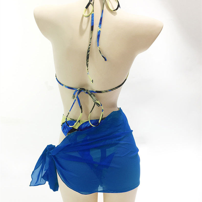Printed bikini one-piece swimsuit with blue sheer skirt wrap and halter-style tie straps