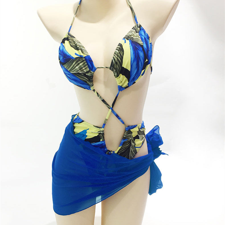 Printed bikini one-piece swimsuit with blue sheer skirt wrap and tie straps, front view