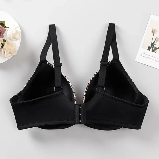 Plus size black bra with leopard-print trim, front view, adjustable straps and clasp