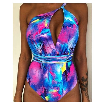 Backless one-piece monokini in bright pink and blue abstract print with tie-front waist