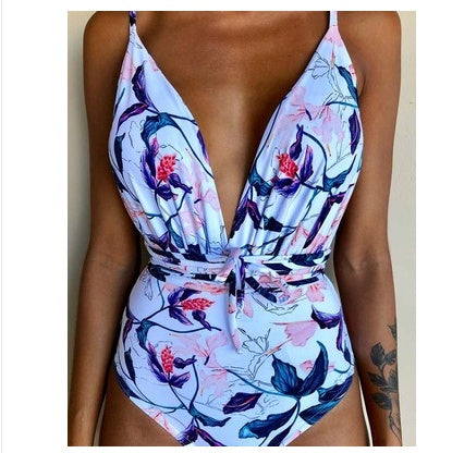 Backless one-piece monokini with blue and pink floral print, deep V and tied waist