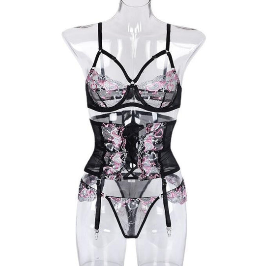 Black 3-piece embroidered lingerie set on mannequin: bra, corset top, thong, garters