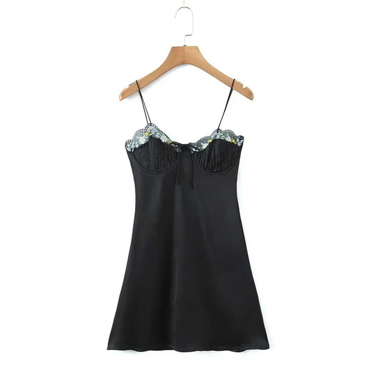 Black slip dress on hanger with lace-trim sweetheart neckline and thin spaghetti straps