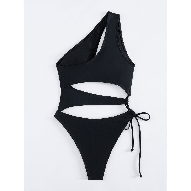 Hollowed-out one-shoulder one-piece swimsuit in black, front view flat lay with tie straps.