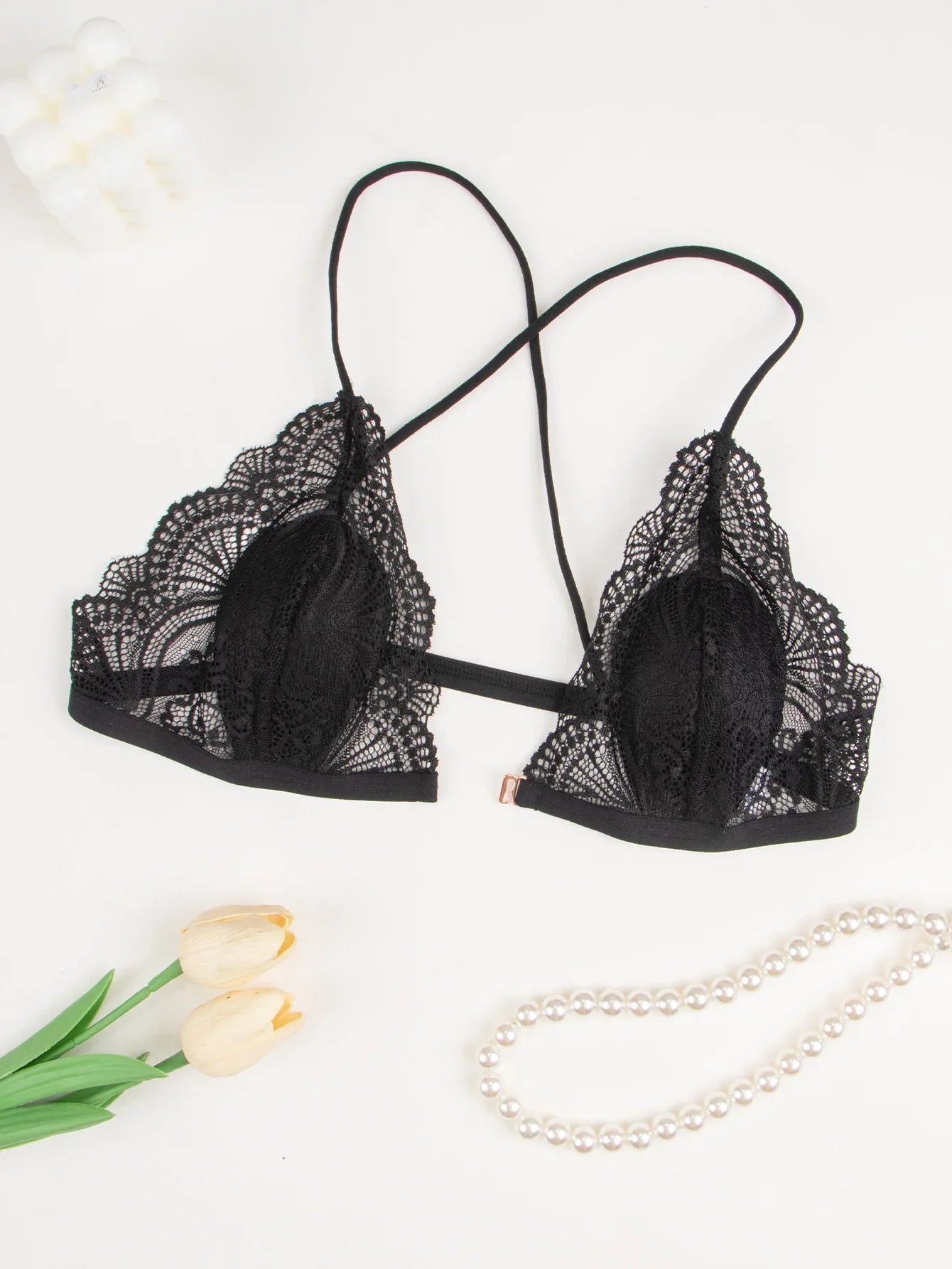 Black lace triangle bra with mesh overlay cups, scalloped edges, crisscross strap back