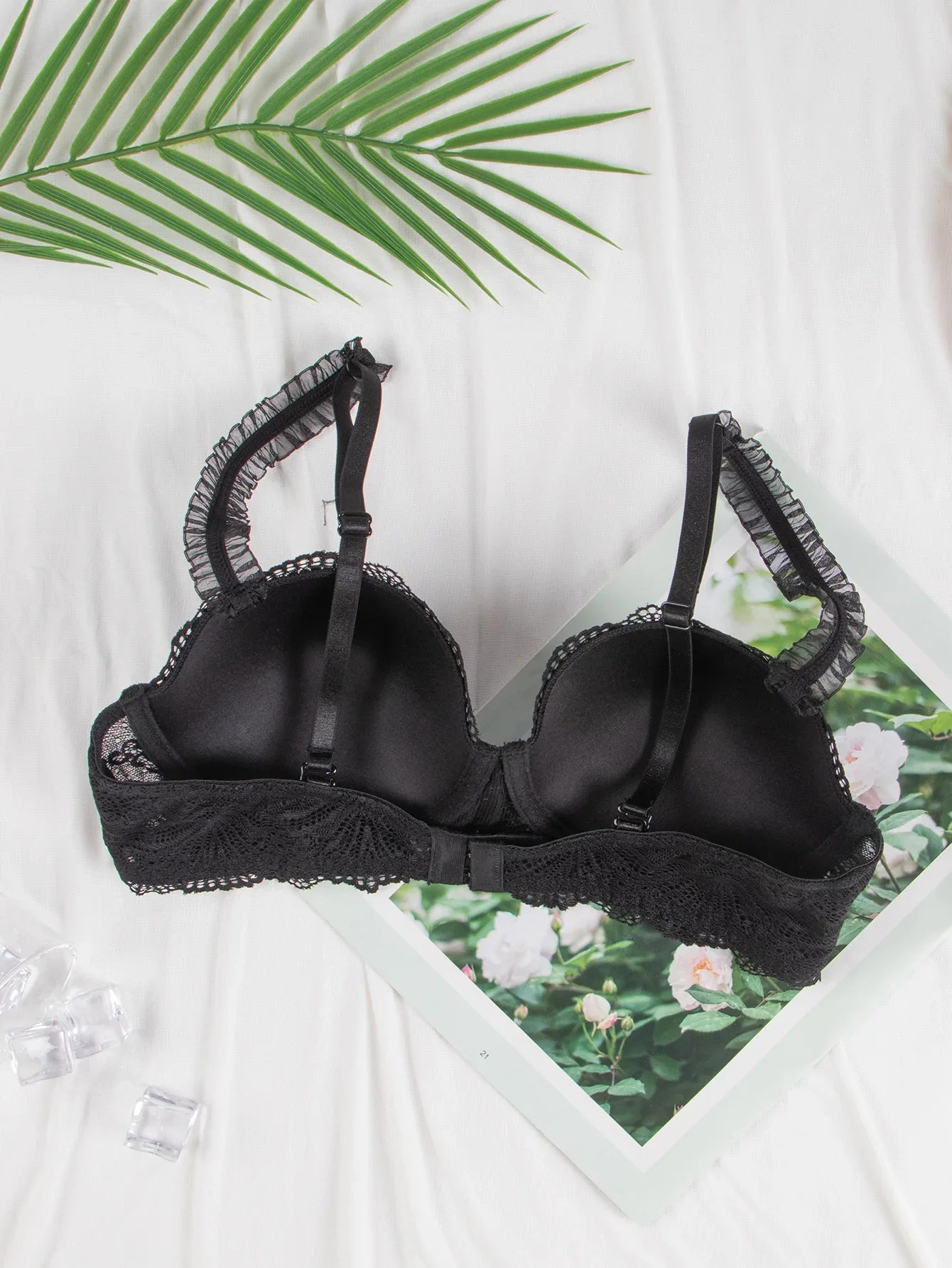 Black lace-trim underwire bra front view, lace cups with underbust band and adjustable straps